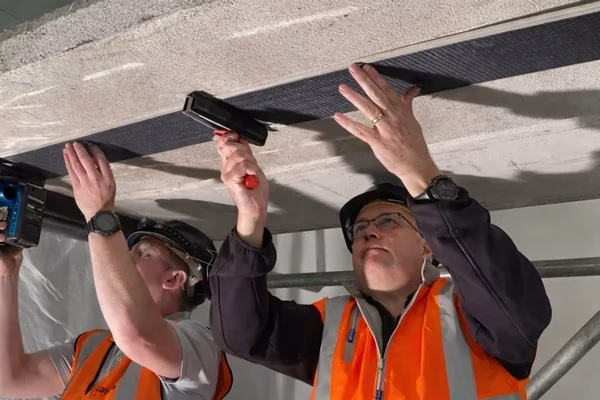 RAAC CFRP strengthening - John Staves and Neil Smuts applying CFRP to Soffit of RAAC. UKs first RAAC Specific solution designed